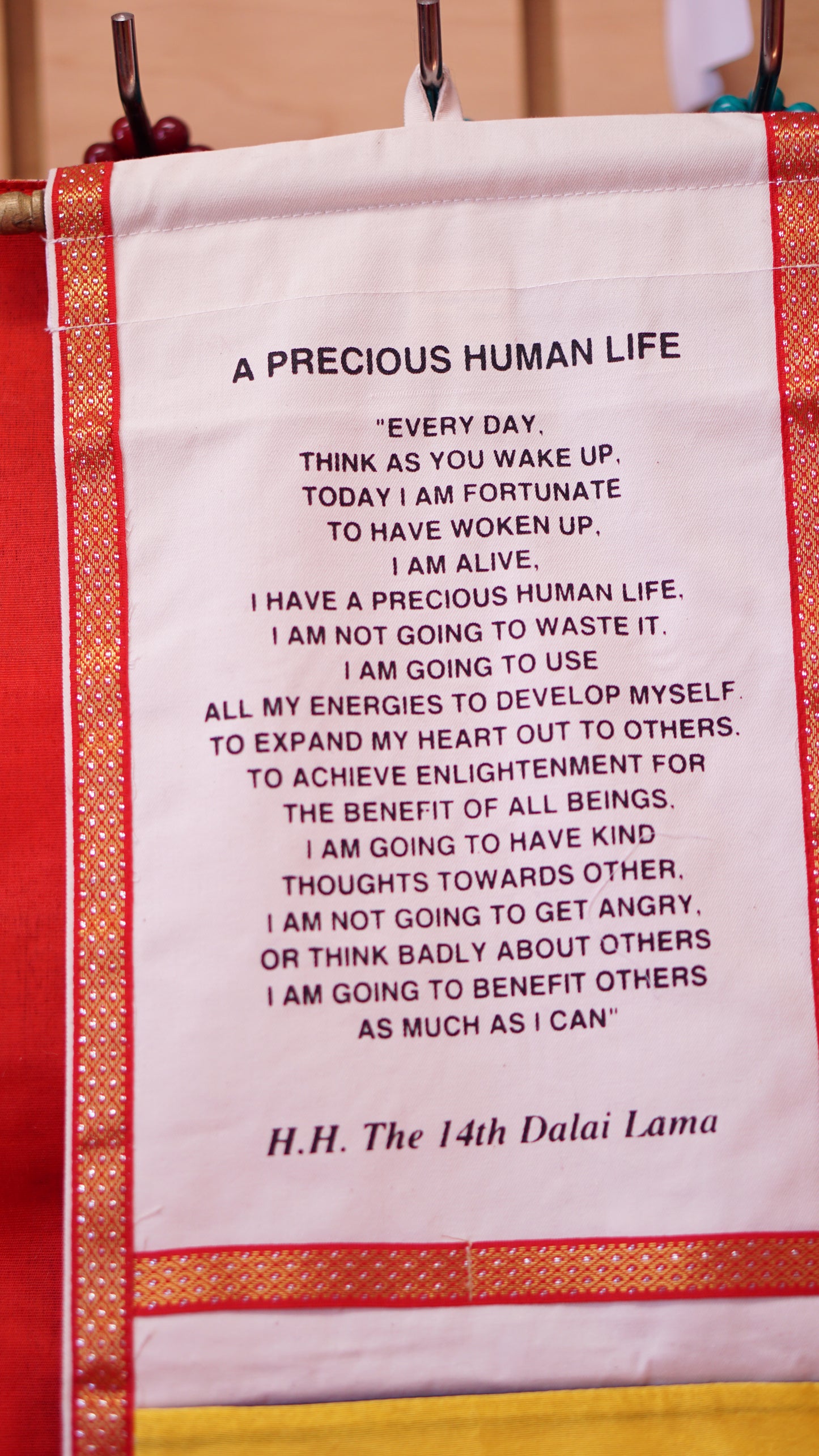 Two pocket decorative wall hanging with His Holiness the Dalai Lama's quote.